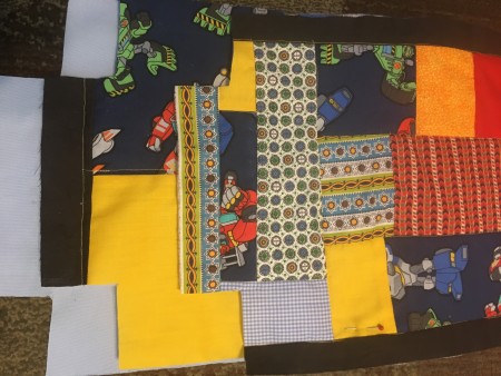 Small pieces of fabric to patchwork together.