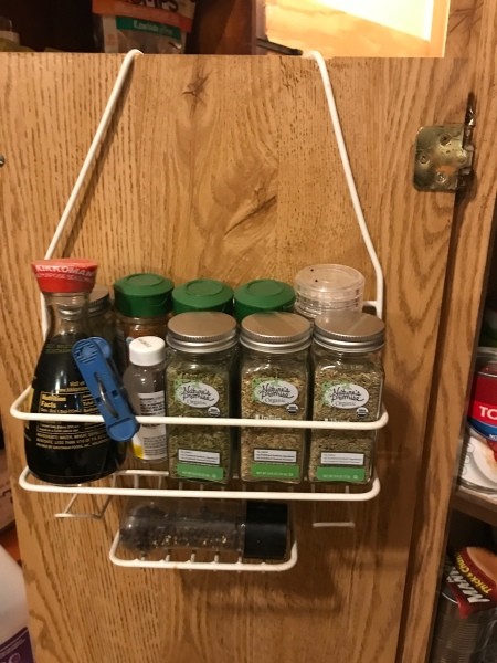A shower caddy being used as a spice rack.