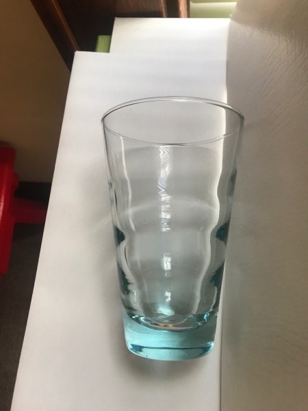 A drinking glass with a blue sheen.