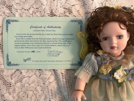 The doll with the certificate of authenticity.