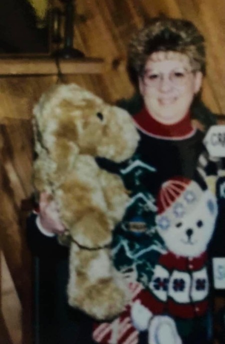A woman holding a stuffed dog.