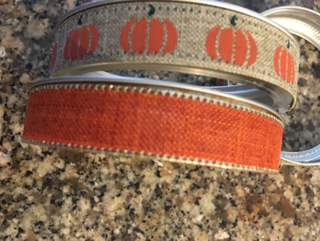 Attaching ribbon to the canning jar lids.