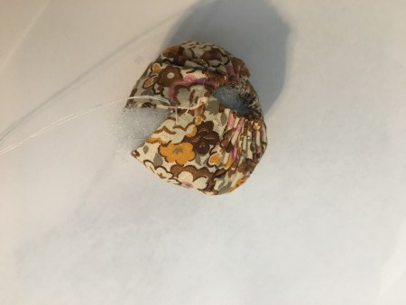 The fabric gathered into a pumpkin shape.