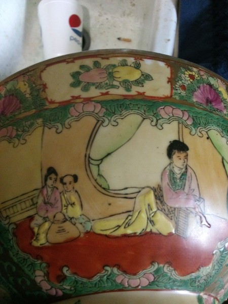 A porcelain bowl with Chinese artwork.