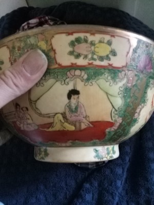 A porcelain bowl with Chinese artwork.