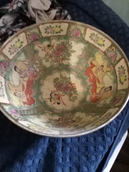 A porcelain bowl with Chinese artwork.