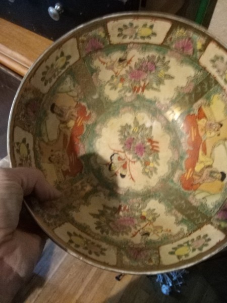 A porcelain bowl with Chinese artwork.