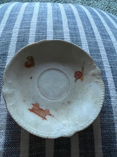 A saucer with pictures around the rim.