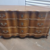 A wooden dresser with drawers.