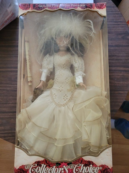 A porcelain doll in a box.