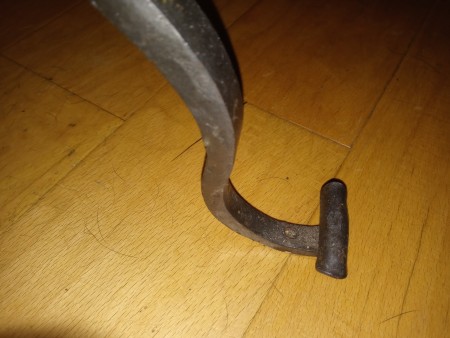 The foot of a metal glass topped table.