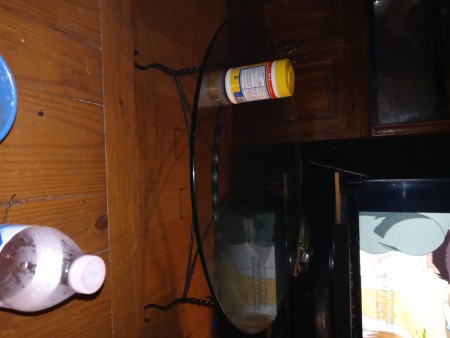 A side view of a glass topped table.