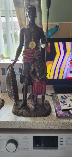 An African sculpture of a warrior and a young boy.