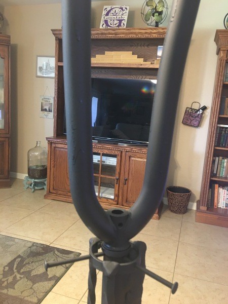 A bike wheel fork attached to the plant stand.