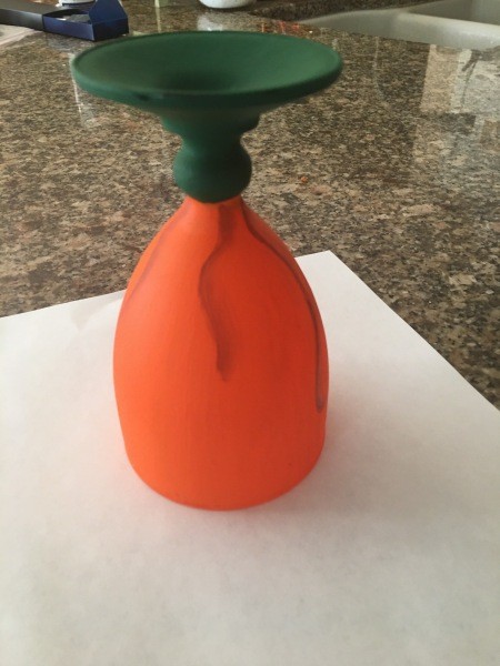 Painting stripes on the orange pumpkin section.