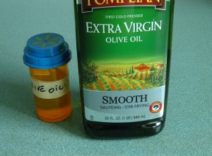 A bottle and container of olive oil.