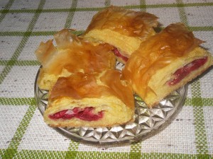 A plate of rolled cherry pie pieces.
