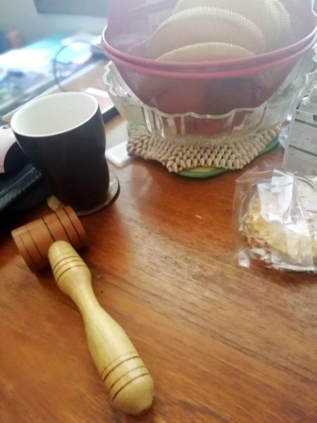 A side view of the wooden tool.