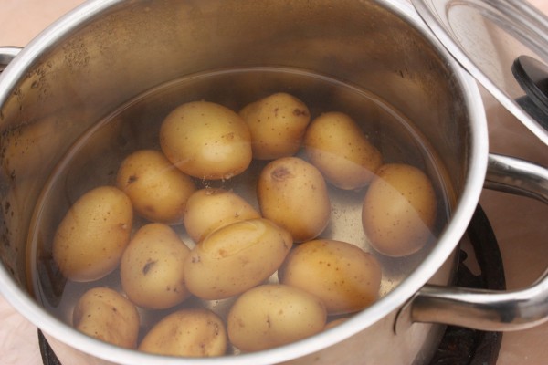Yellow potatoes in a pot of water.