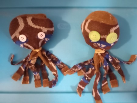 Two socks made into octopus dolls.