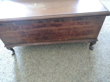 A cedar chest with small legs.