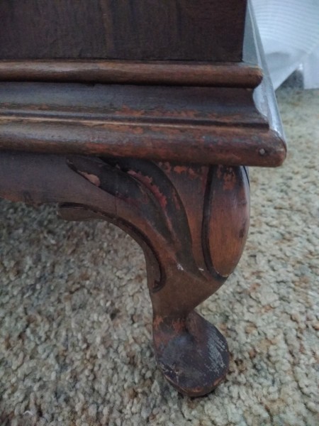 The carved leg of a cedar chest.