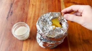 Adding foil to the sides of a candle.