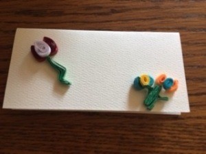 Quilled flowers on a card.
