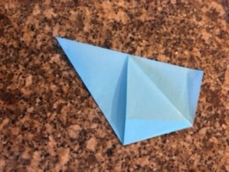 A piece of origami paper folded into a triangle.