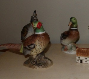 Three decorative liquor bottles resembling birds.