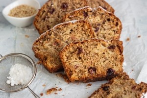 A loaf of banana bread with fruit.