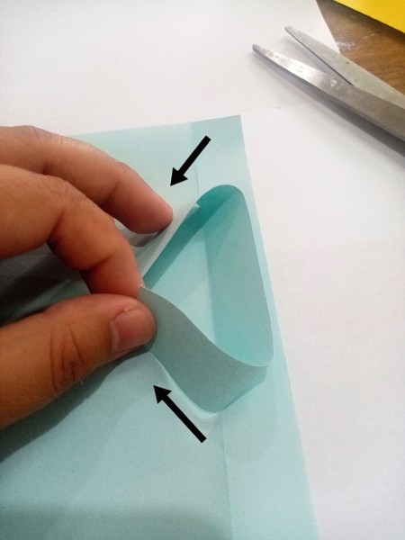 Folding the top of the card to resemble a shirt.
