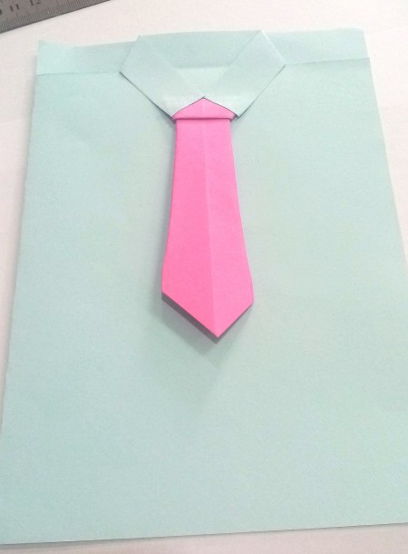Adding the origami tie.
