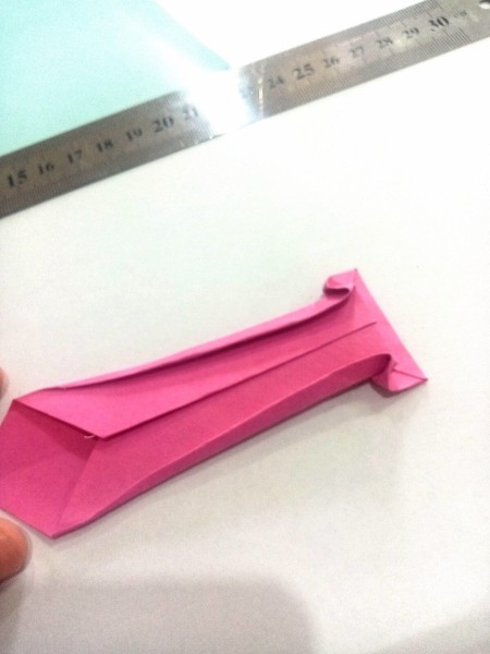 Forming the origami necktie.