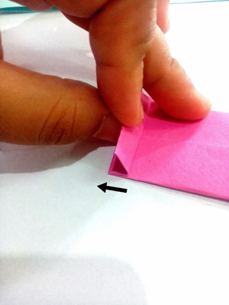 Folding the end of the necktie.