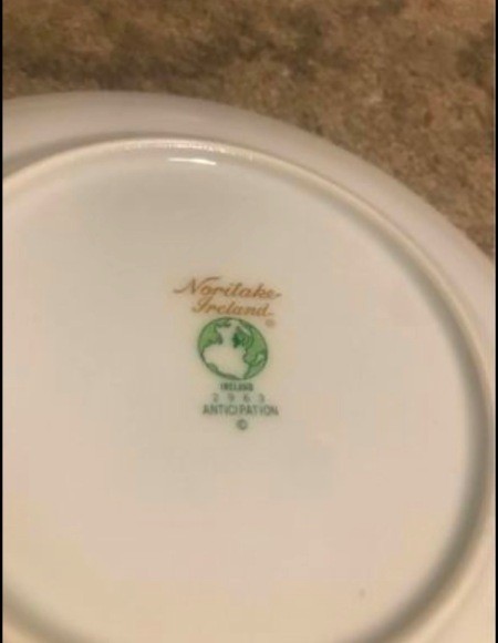 The markings on the back of a china plate.