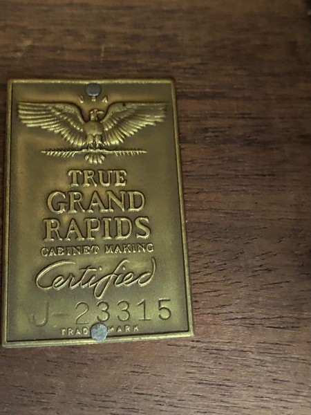 A plaque certifying the manufacturer of the dresser.