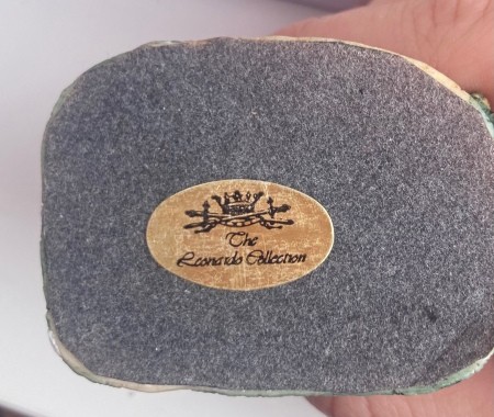 The sticker on the bottom of a decorative cottage.