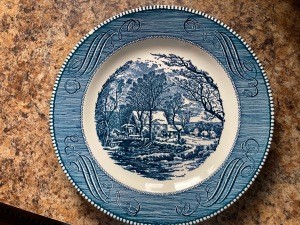 A blue Currier and Ives collectible plate.