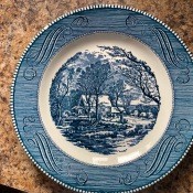 A blue Currier and Ives collectible plate.