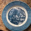 A blue Currier and Ives collectible plate.