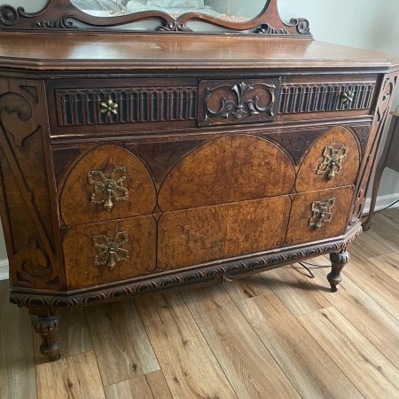 A wooden dresser with decorative wood.