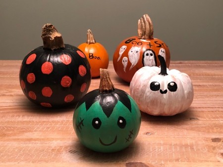 A collection of painted pumpkins.
