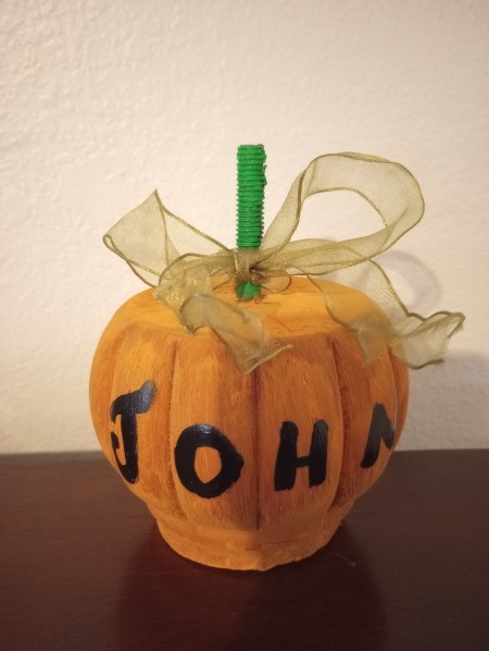 A pumpkin made from a round chair leg.