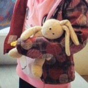 A child holding a stuffed bunny.
