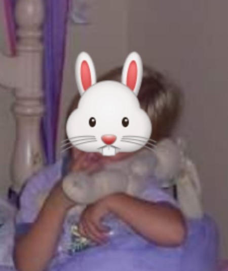 A child holding a stuffed bunny.