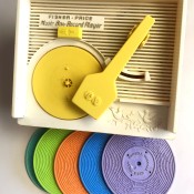 A Fisher Price record player with 5 records.