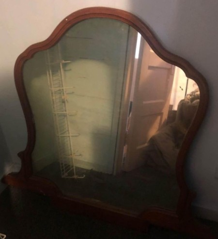 The mirror on a dressing table.