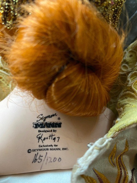 The markings on the back of a porcelain doll.