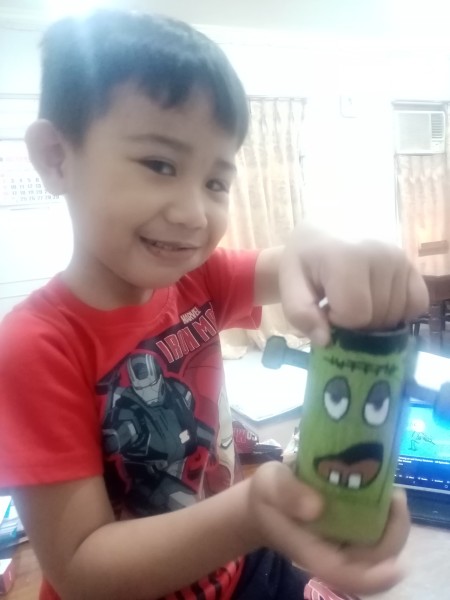 A boy playing with the face switch toy.